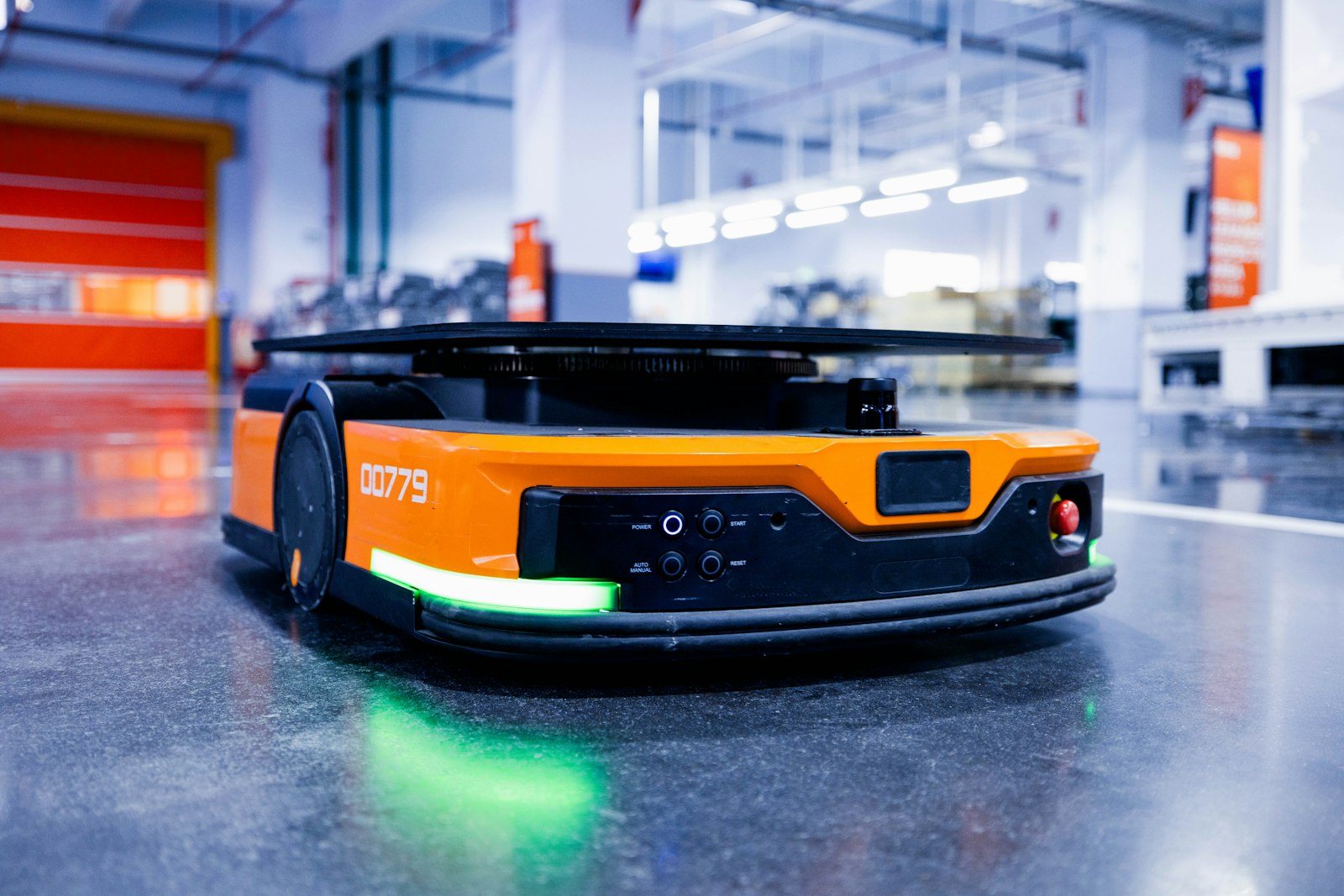 Autonomous mobile robot operating on a factory floor with an active safety light